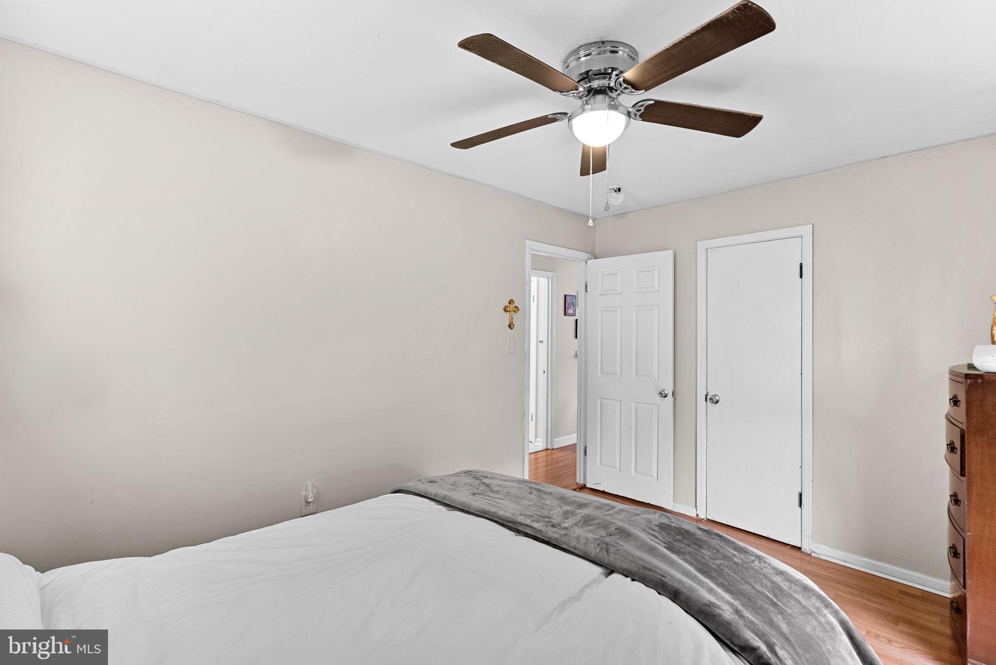 219 Josephine Street Berryville, VA 22611 - Photo 15 of 26 a bedroom with a large bed and a ceiling fan
