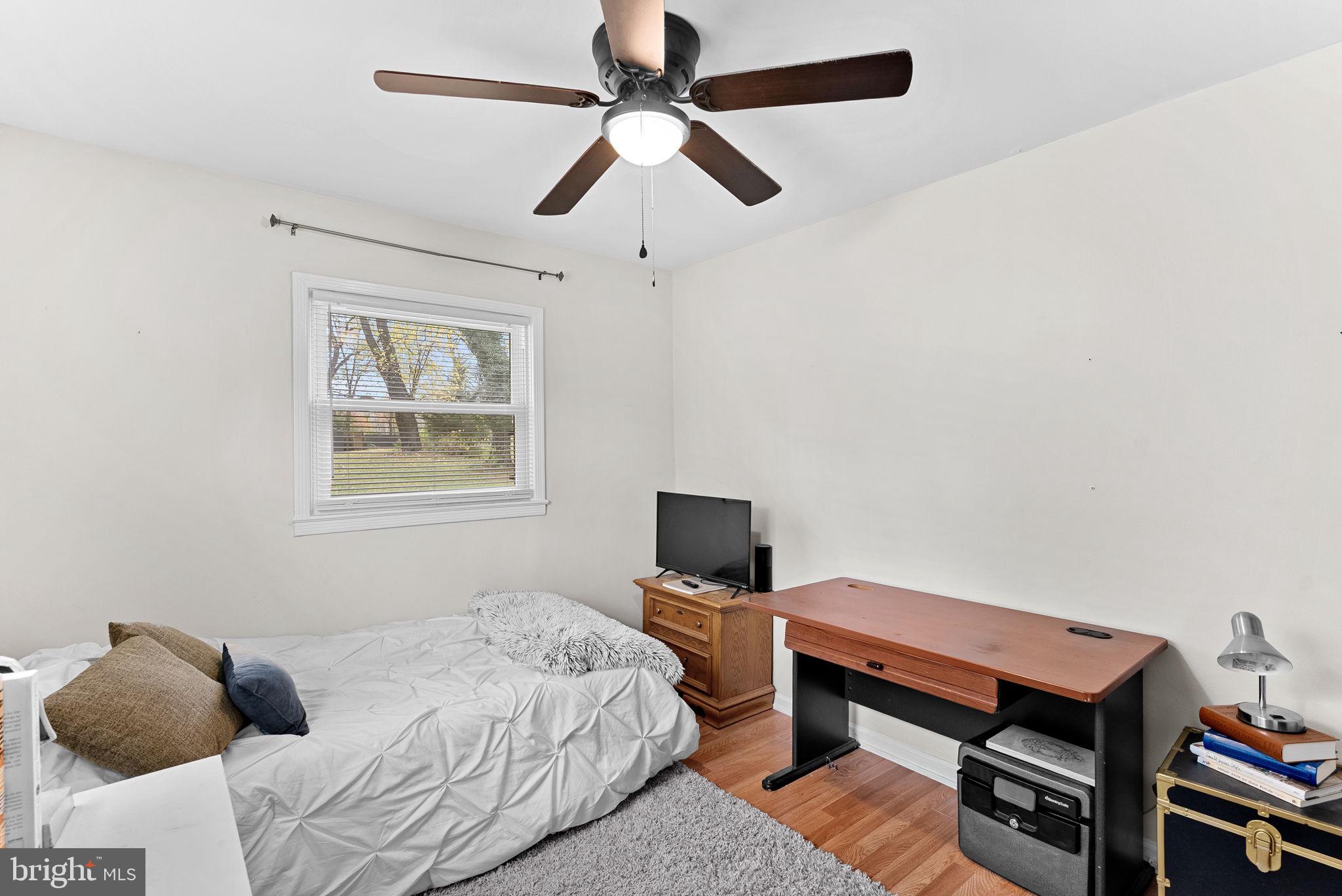 219 Josephine Street Berryville, VA 22611 - Photo 19 of 26 a bedroom with a bed and a chair