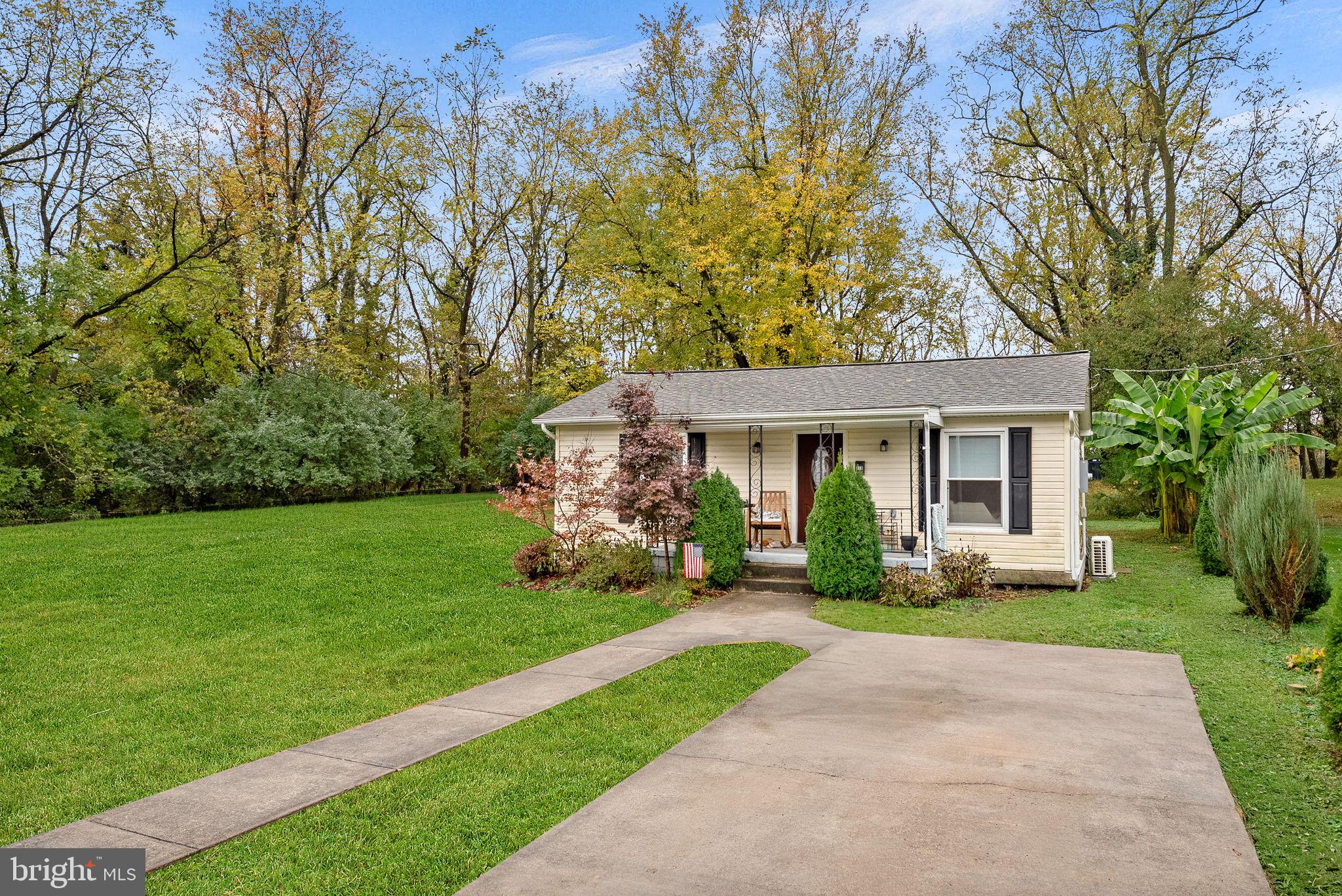 219 Josephine Street Berryville, VA 22611 - Photo 3 of 26 a front view of a house with a garden and yard