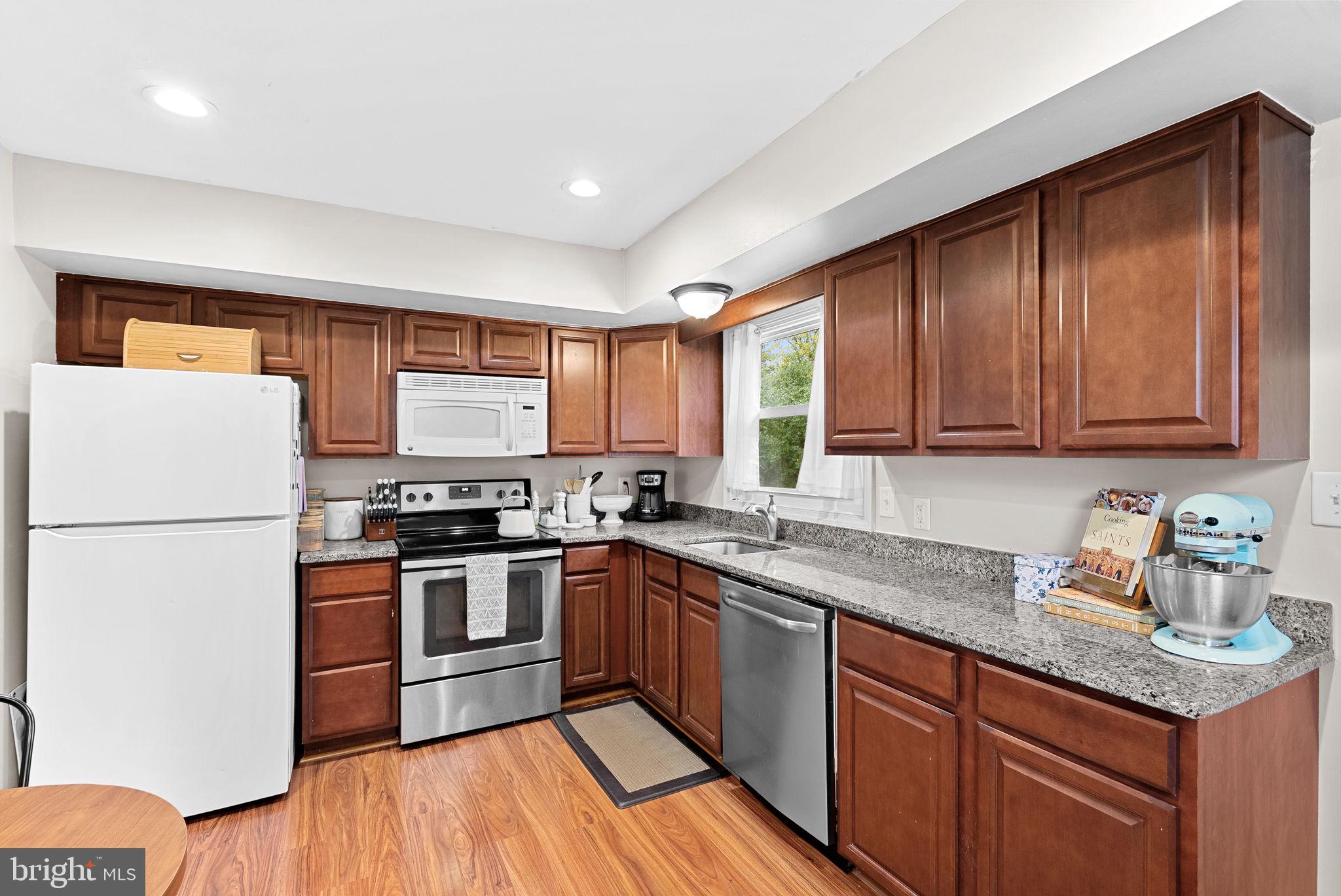219 Josephine Street Berryville, VA 22611 - Photo 10 of 26 a kitchen with stainless steel appliances granite countertop a stove a sink dishwasher a refrigerator and cabinets with wooden floor