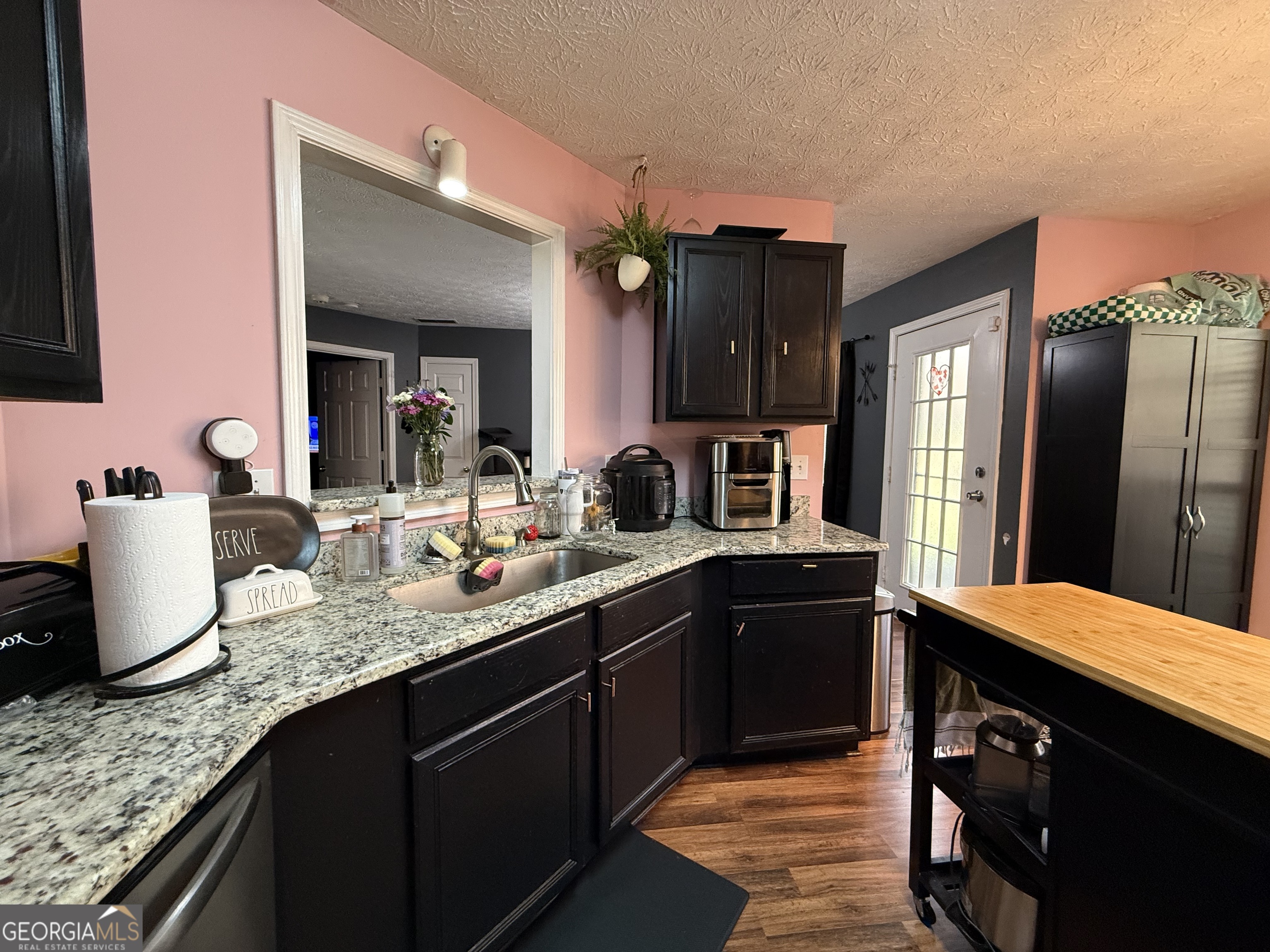 55 Jill Lane Covington, GA 30016 - Photo 11 of 52 a kitchen with stainless steel appliances granite countertop a sink stove and refrigerator