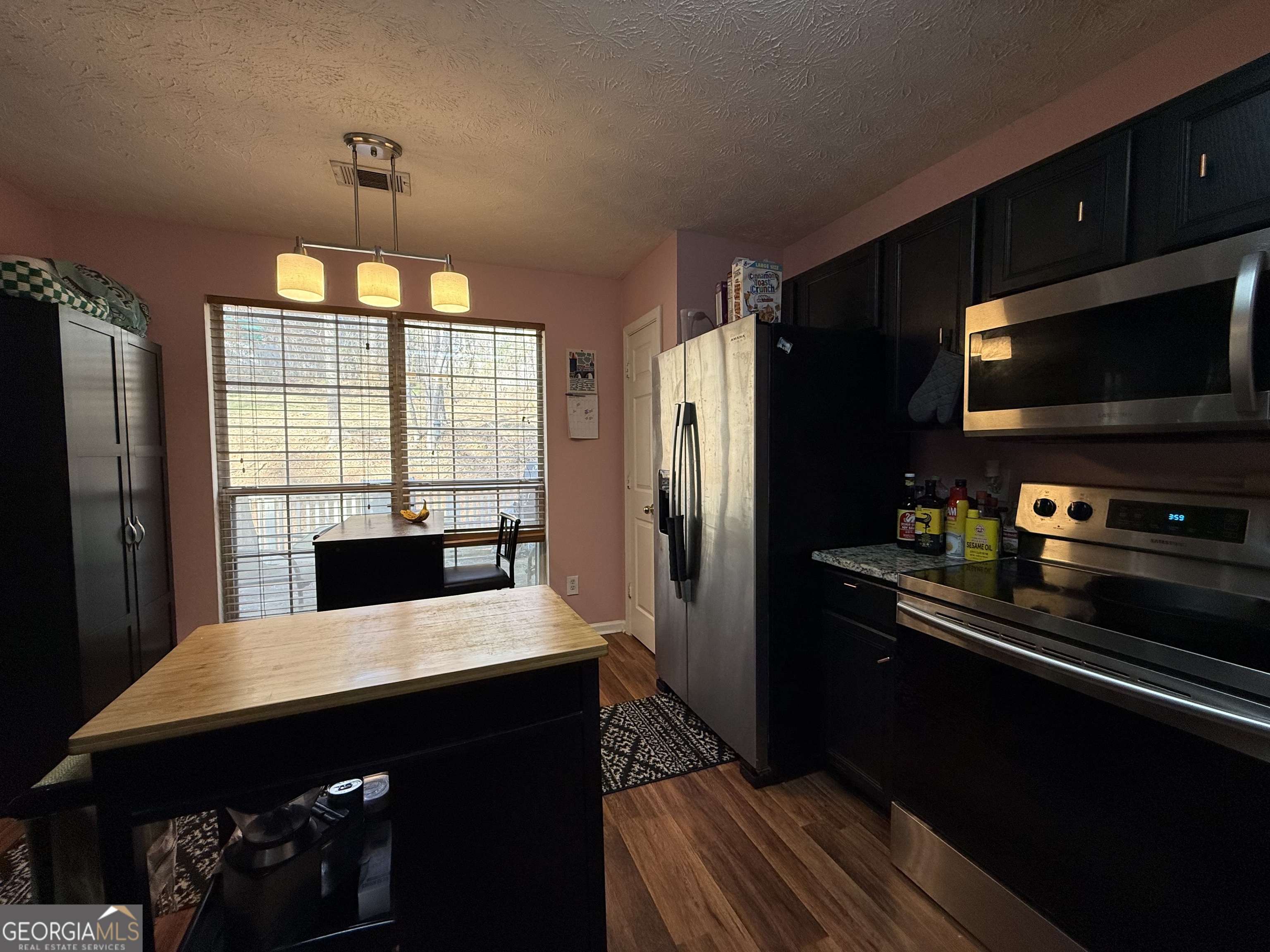 55 Jill Lane Covington, GA 30016 - Photo 12 of 52 a kitchen with a refrigerator and a stove top oven