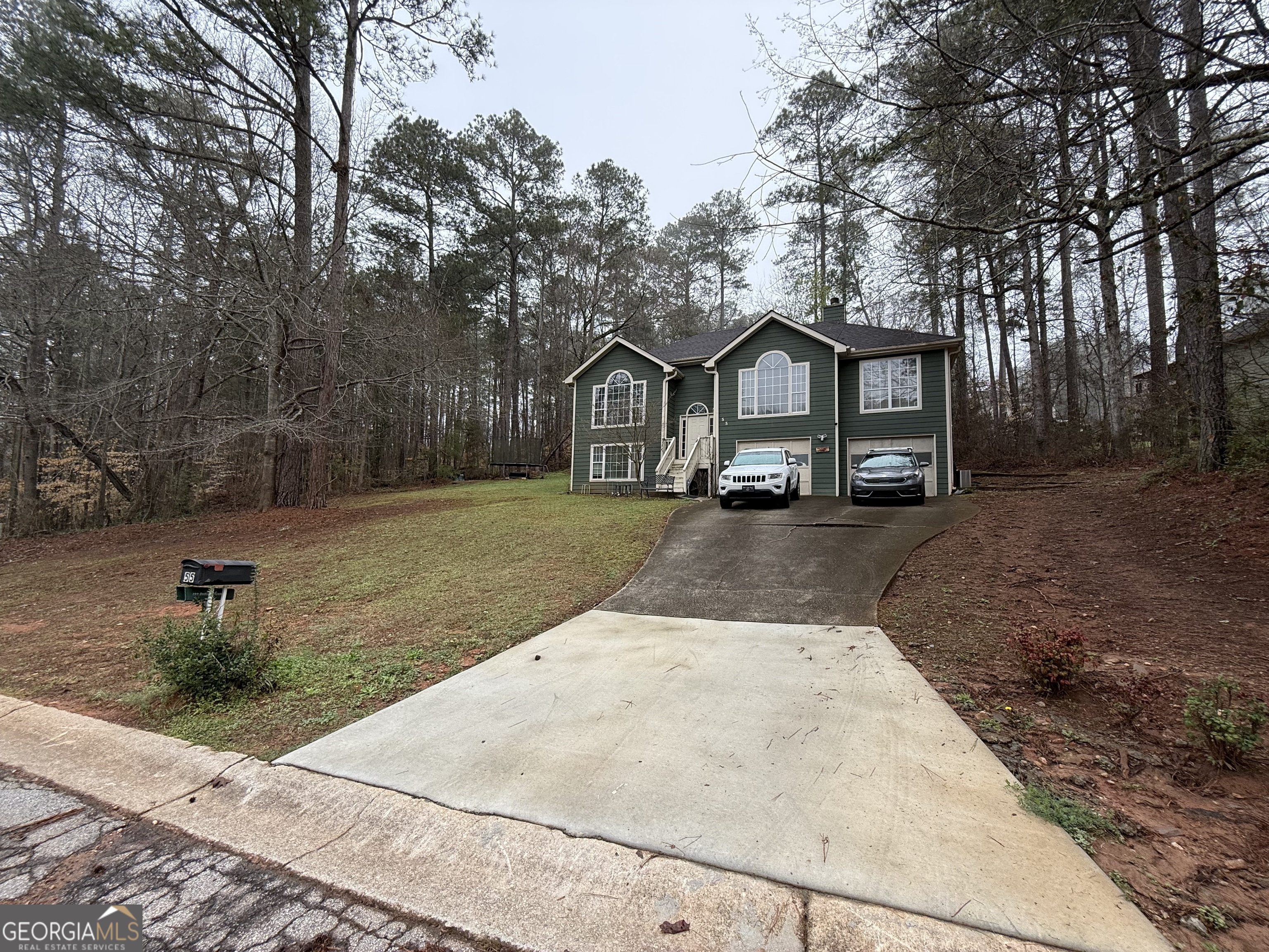 55 Jill Lane Covington, GA 30016 - Photo 21 of 52 a front view of a house with a yard and garage