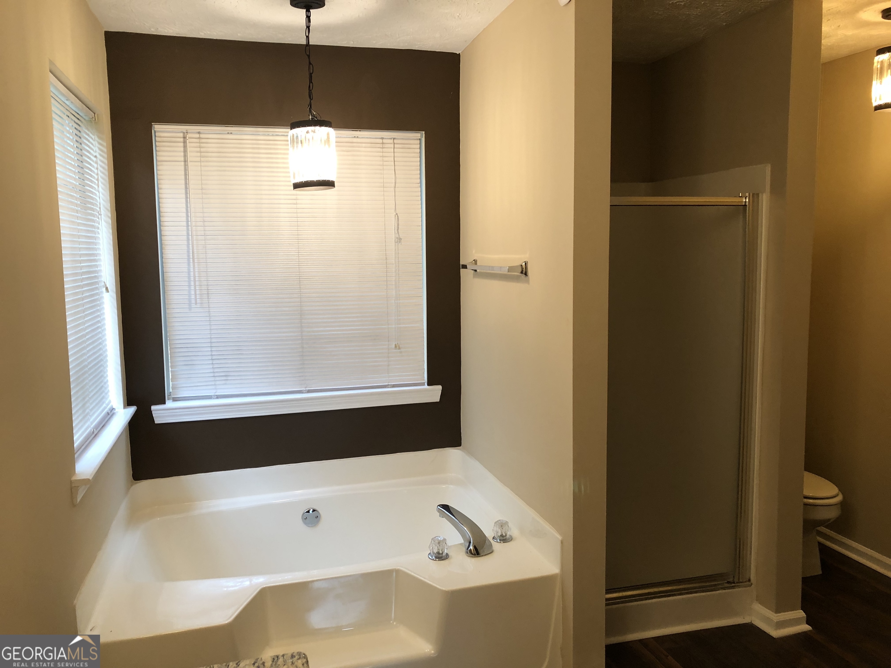 55 Jill Lane Covington, GA 30016 - Photo 27 of 52 a bathroom with a bathtub and a shower