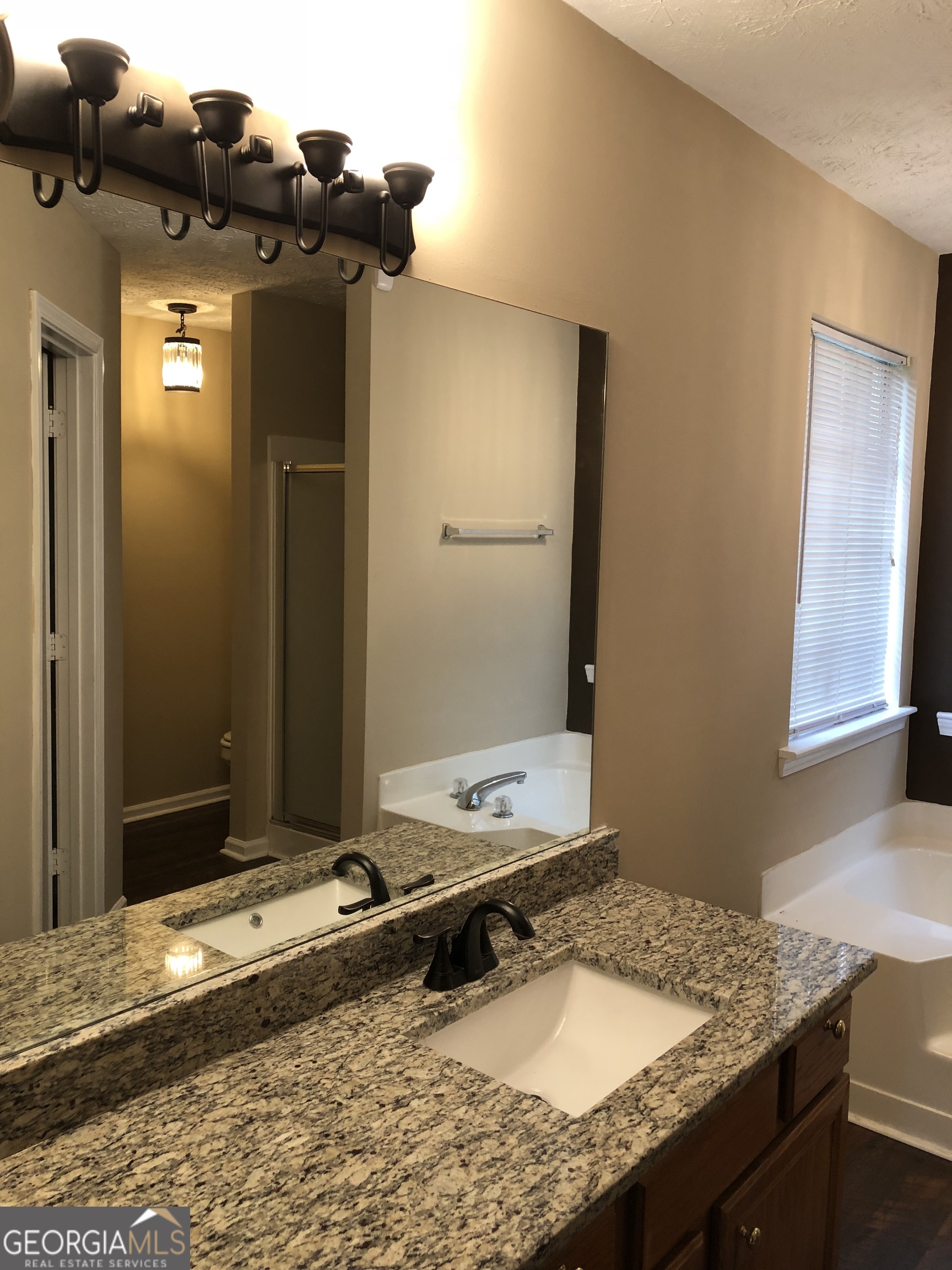 55 Jill Lane Covington, GA 30016 - Photo 29 of 52 a bathroom with a granite countertop sink and a mirror