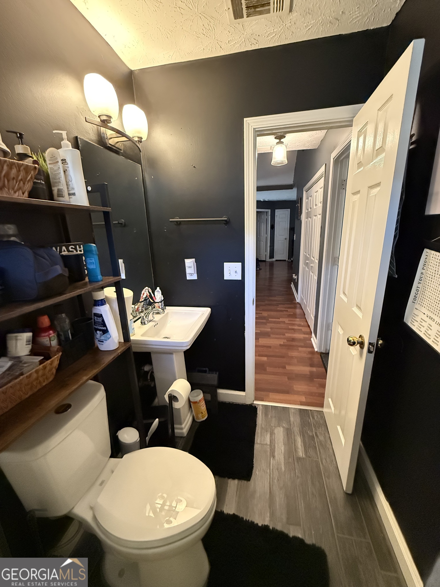 55 Jill Lane Covington, GA 30016 - Photo 35 of 52 a bathroom with a sink a toilet a mirror and vanity