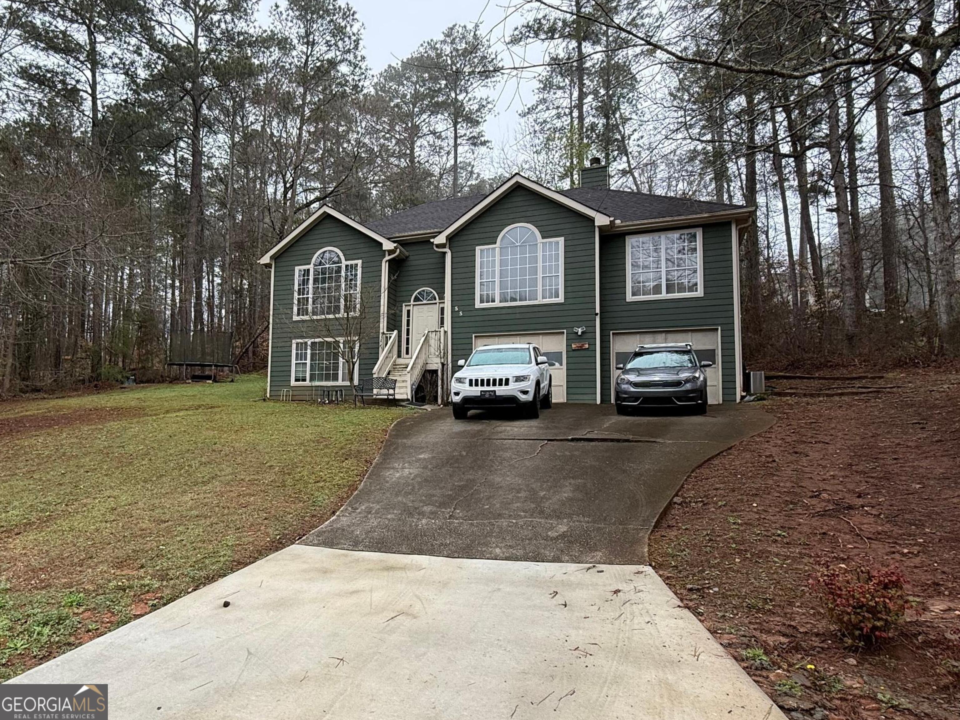 55 Jill Lane Covington, GA 30016 - Photo 50 of 52 a front view of a house with a yard and garage