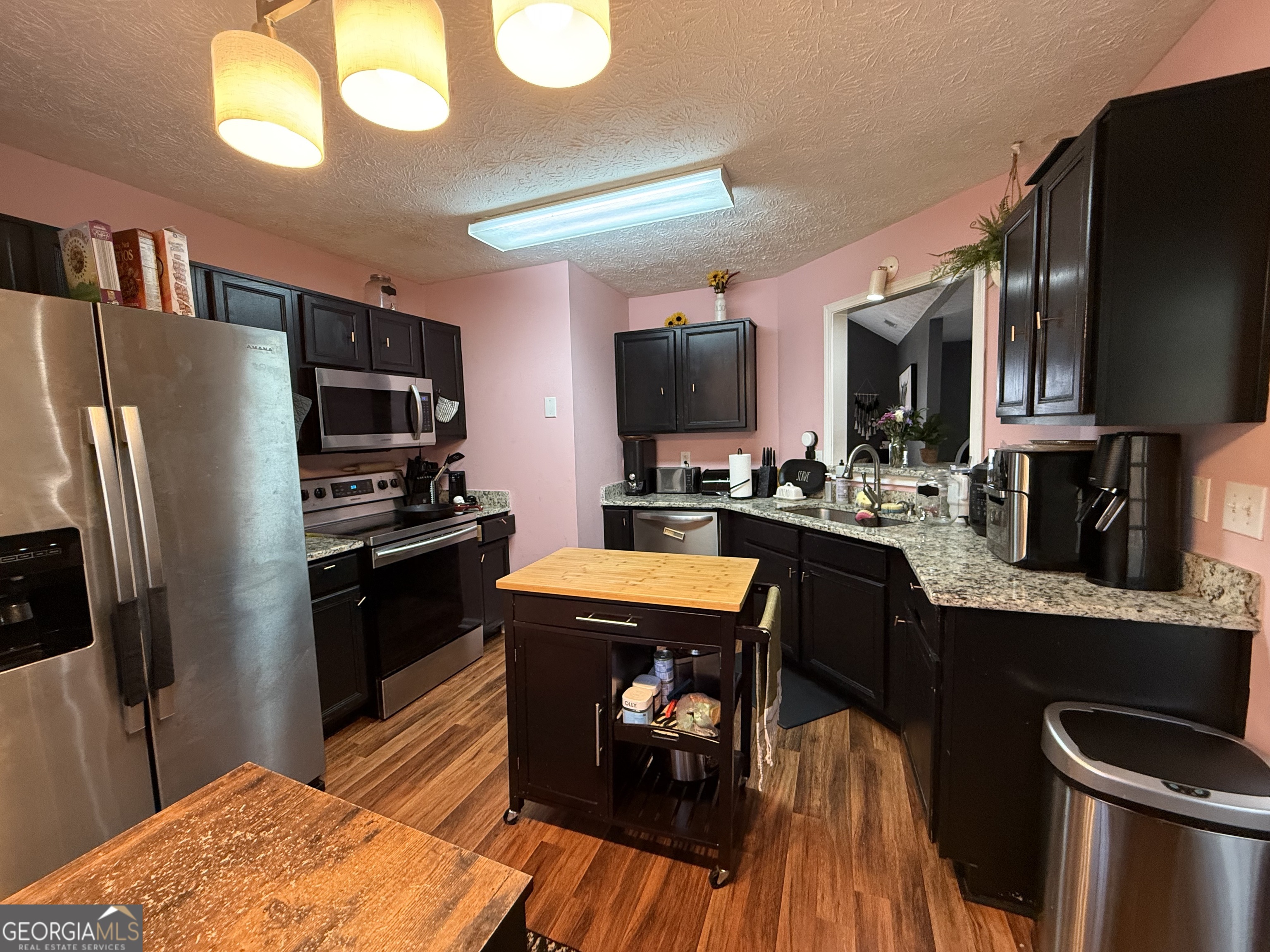 55 Jill Lane Covington, GA 30016 - Photo 10 of 52 a kitchen with stainless steel appliances granite countertop a refrigerator stove top oven a sink and dishwasher