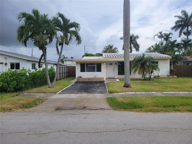 a front view of a house with garden and porch