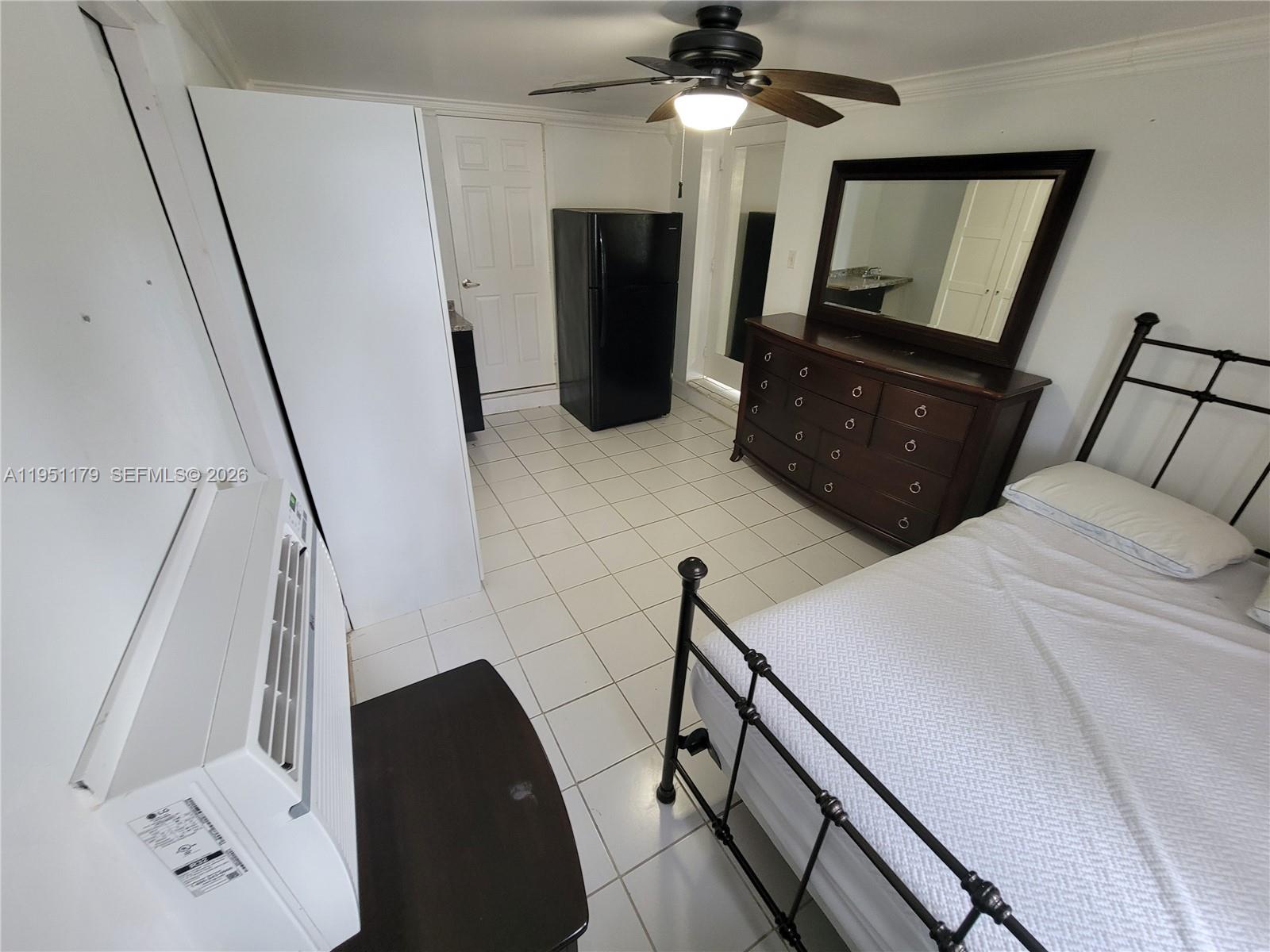 1533 Cleveland Street Hollywood, FL 33020 - Photo 3 of 7 a bedroom with a bed and a mirror on the side