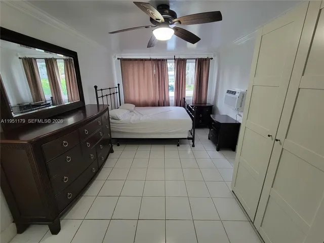 a spacious bathroom with a bathtub and a chandelier