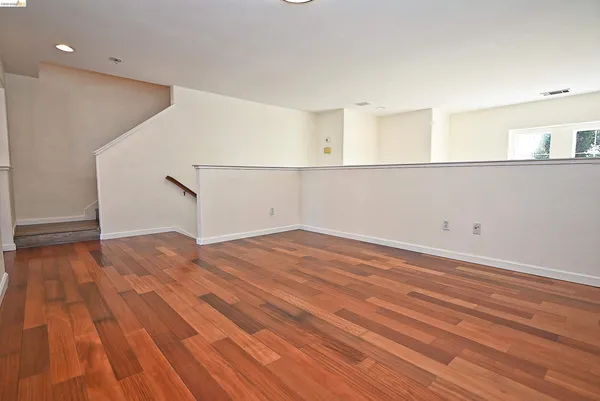 a view of a room with wooden floor