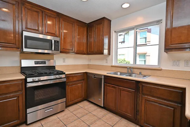 a kitchen with a sink stove and microwave
