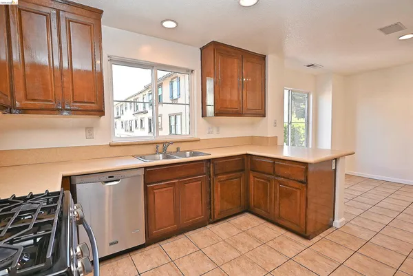 a kitchen with stainless steel appliances granite countertop a sink and a stove