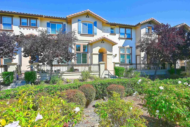 a front view of a house with a yard and outdoor seating
