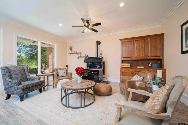 a living room with furniture a rug and white walls
