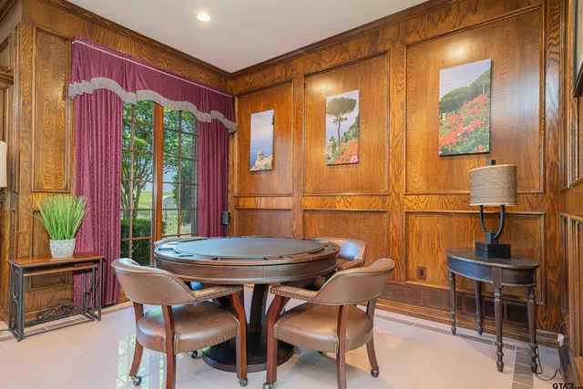 a view of a dining room with furniture and a window