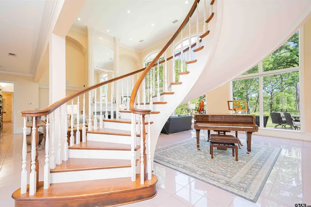 a view of staircase with furniture and a floor to ceiling window