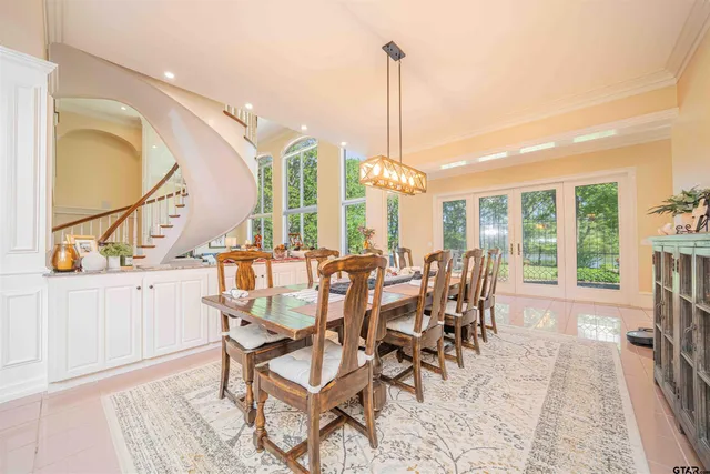 a view of a dining room and livingroom with furniture wooden floor a chandelier