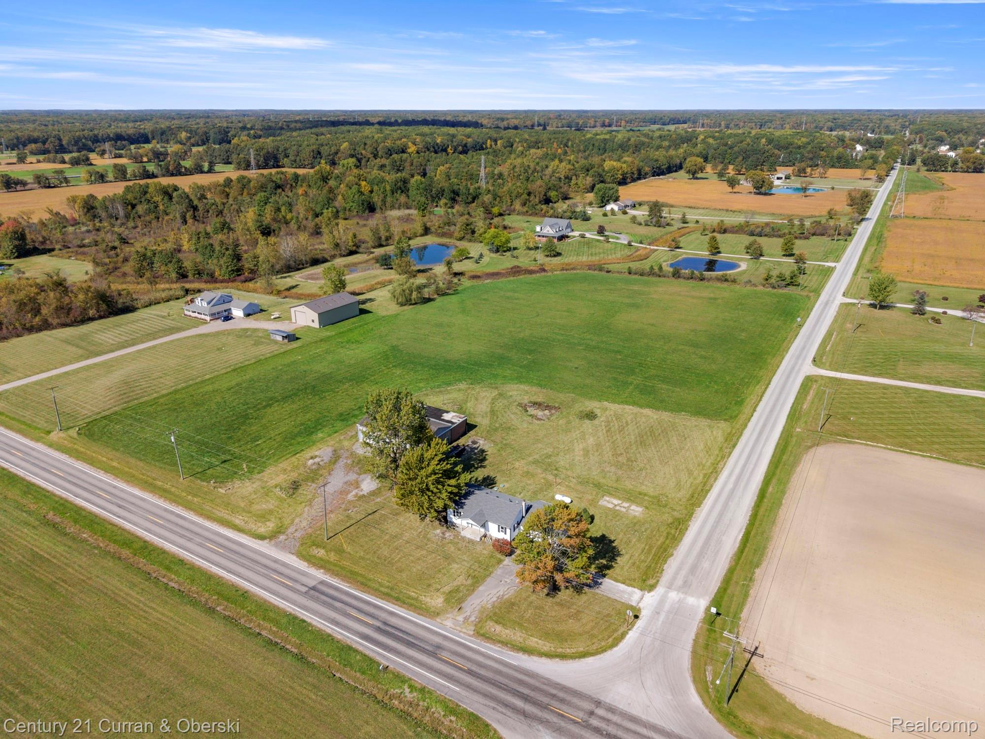 7504 Meisner Road Casco, MI 48064 - Photo 25 of 27 Expansive acreage featuring multiple cleared fields, two distinct ponds, and a standalone outbuilding
