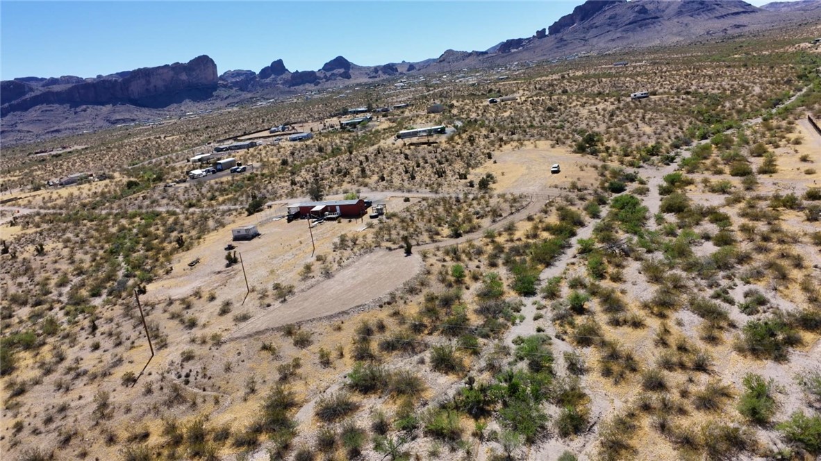 1386 Don Luis Road Golden Valley, AZ 86413 - Photo 40 of 47 Expansive desert landscape with several properties visible, set against a backdrop of rugged mountains