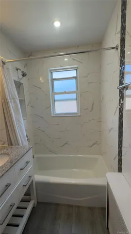 a bathroom with a bathtub and a shower