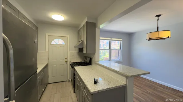 a view of a kitchen with a sink and a window