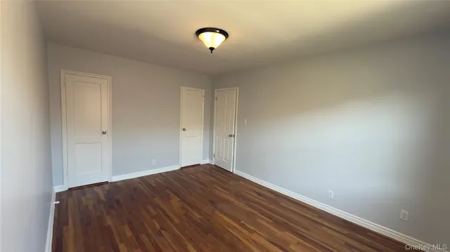 a view of room with wooden floor