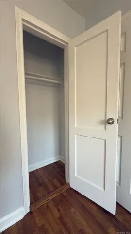 a room with a bench and wooden floor