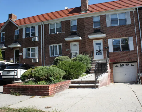 a front view of a house with lots of garage and plants