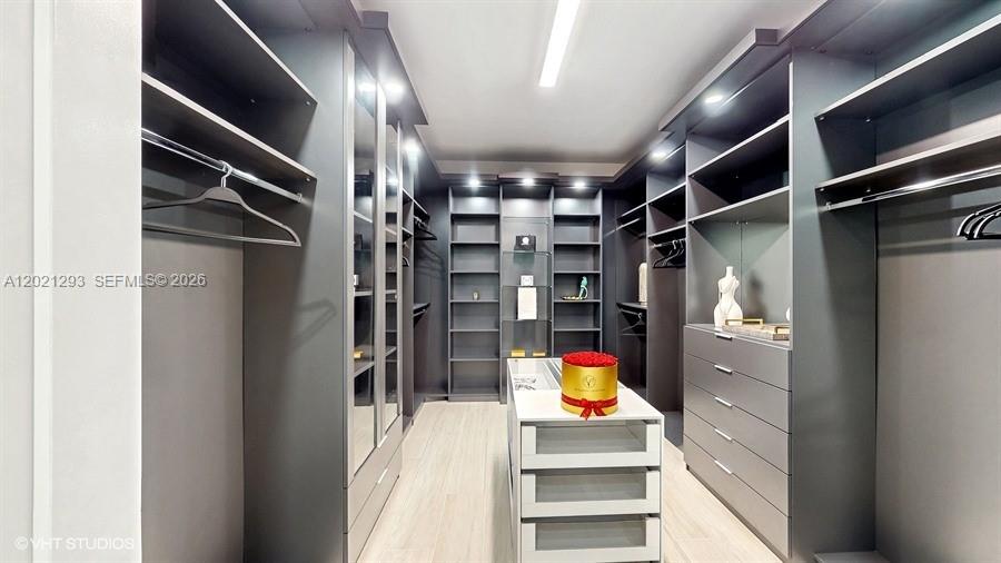 8350 Royal County Down Road Boca Raton, FL 33434 - Photo 21 of 52 a view of walk in closet with clothes and shoes