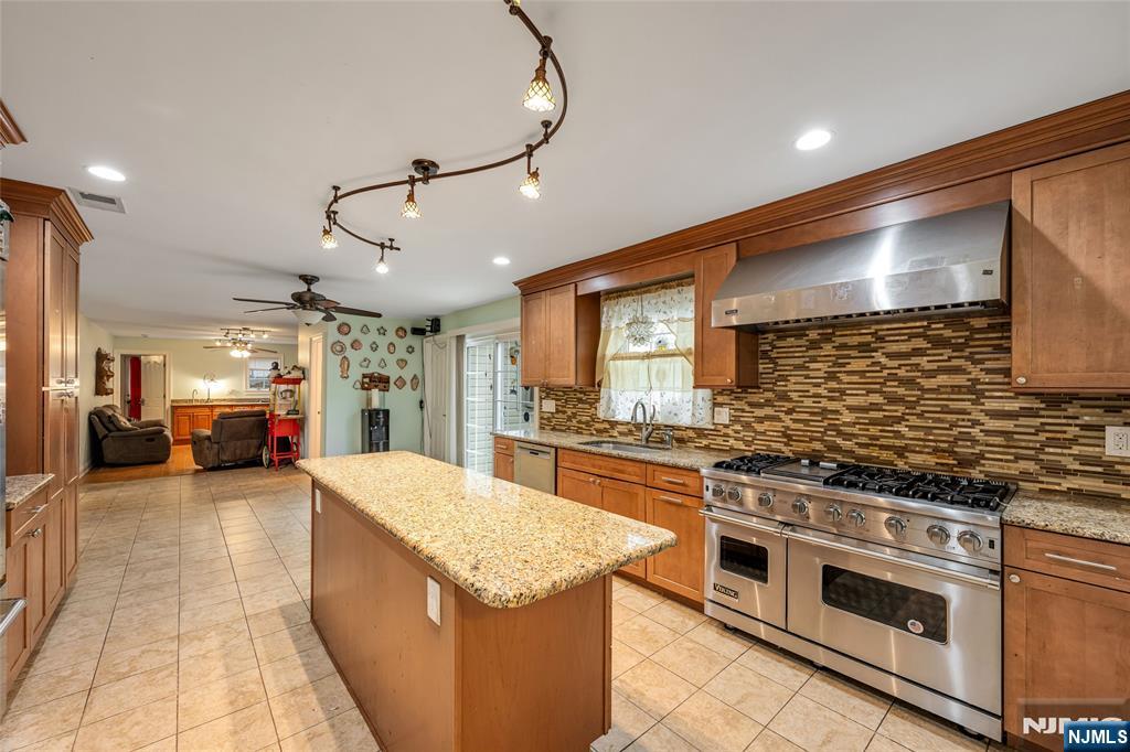 255 Knoll Road Lake Hiawatha, NJ 07034 - Photo 11 of 35 a large kitchen with stainless steel appliances granite countertop a stove and cabinets