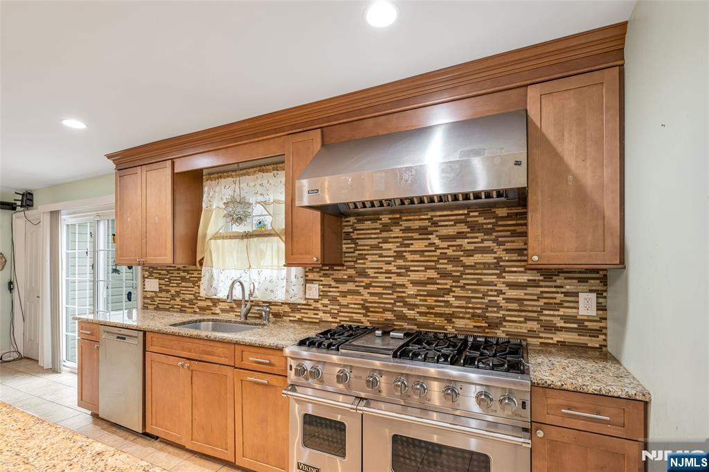 255 Knoll Road Lake Hiawatha, NJ 07034 - Photo 15 of 35 a kitchen with stainless steel appliances granite countertop a stove and a sink