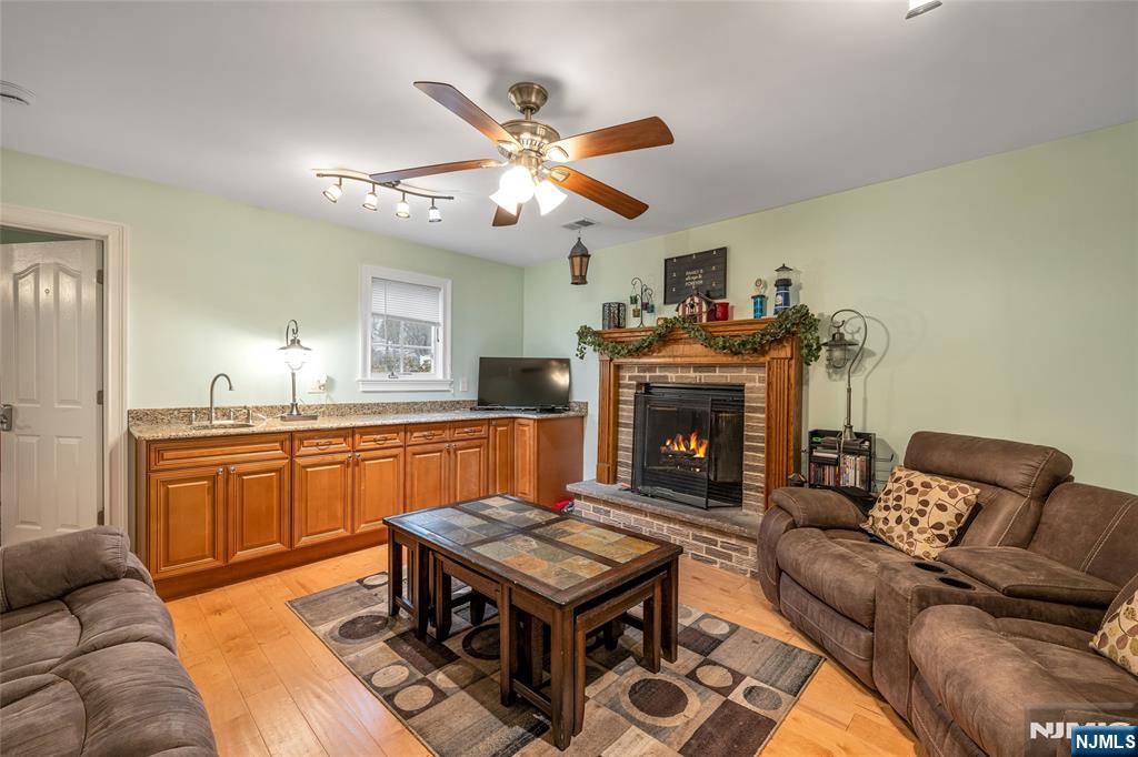 255 Knoll Road Lake Hiawatha, NJ 07034 - Photo 20 of 35 a living room with furniture a dining table and a fireplace