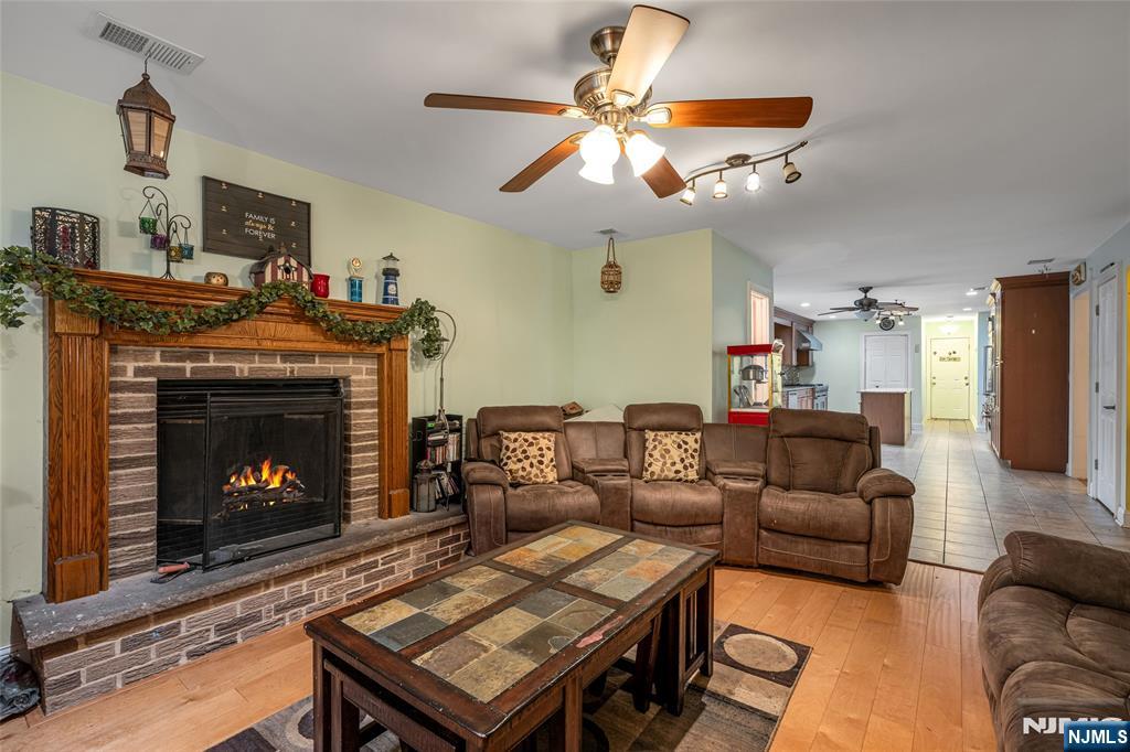 255 Knoll Road Lake Hiawatha, NJ 07034 - Photo 21 of 35 a living room with furniture a fireplace and a flat screen tv