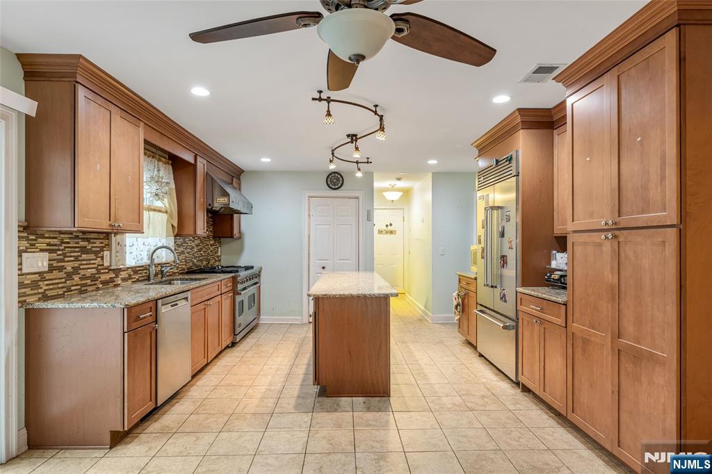 255 Knoll Road Lake Hiawatha, NJ 07034 - Photo 10 of 35 a kitchen with stainless steel appliances a refrigerator sink and cabinets