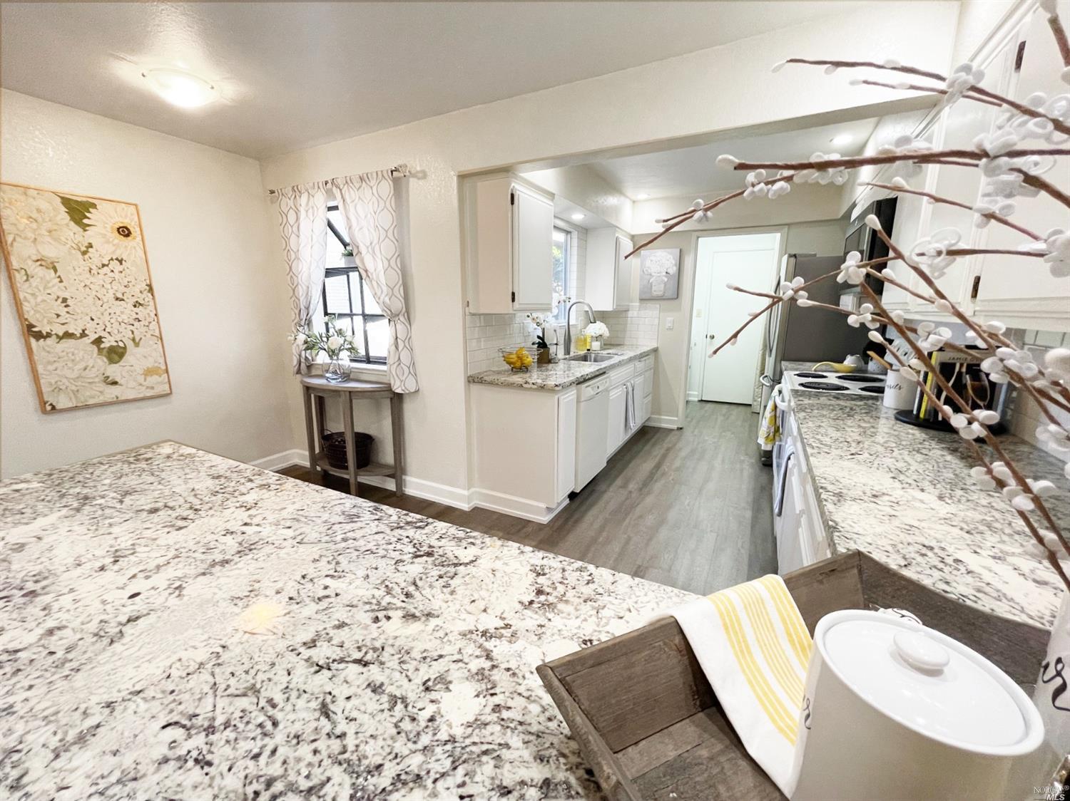 a bedroom with a bed and a flat tv screen on the dresser