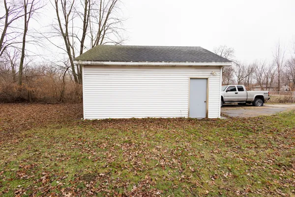 a view of garage and yard