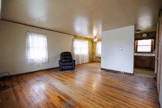 a view of a livingroom with wooden floor and a window