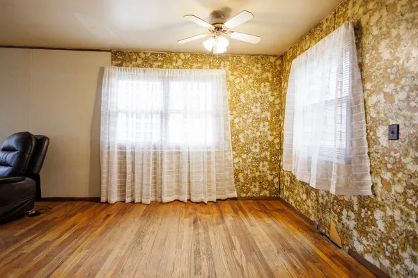 a view of a livingroom with wooden floor and a window