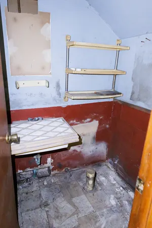 a wooden bench sitting in a kitchen
