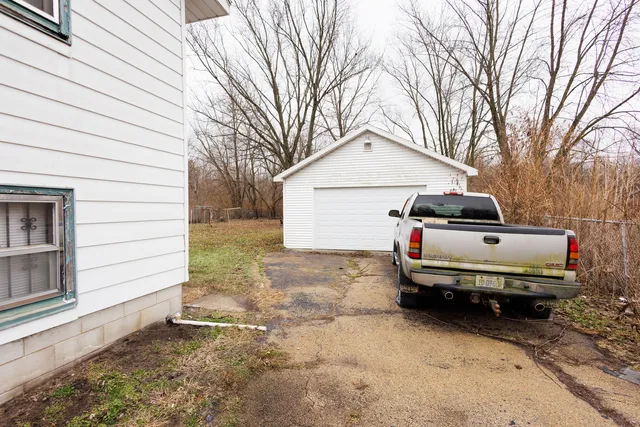 a car parked in front of white house