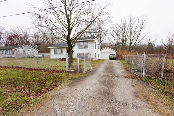 a view of a yard with a house and a tree