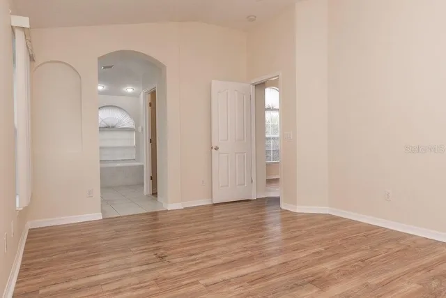 a view of empty room with wooden floor