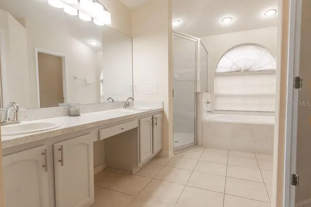 a bathroom with a sink a mirror and a shower