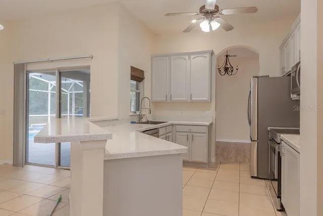 a kitchen with a sink appliances and cabinets