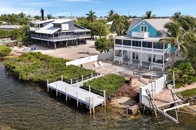 an aerial view of a house with a yard and sitting area