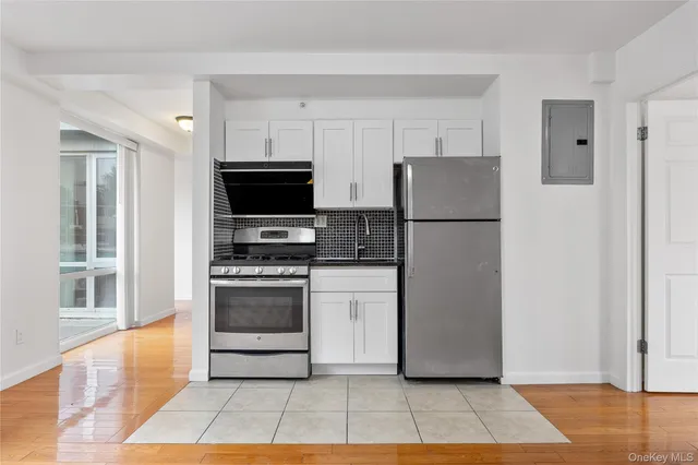 a kitchen with a refrigerator and a stove