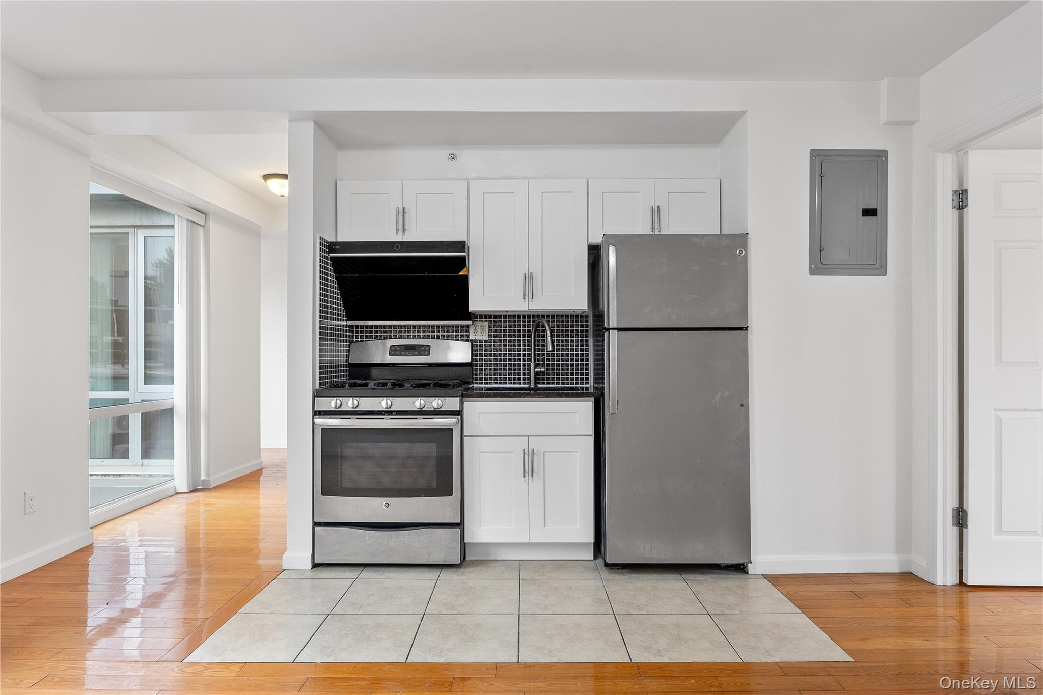 139-30 34th Avenue, Unit 3B Queens, NY 11354 - Photo 14 of 20 a kitchen with a refrigerator and a stove