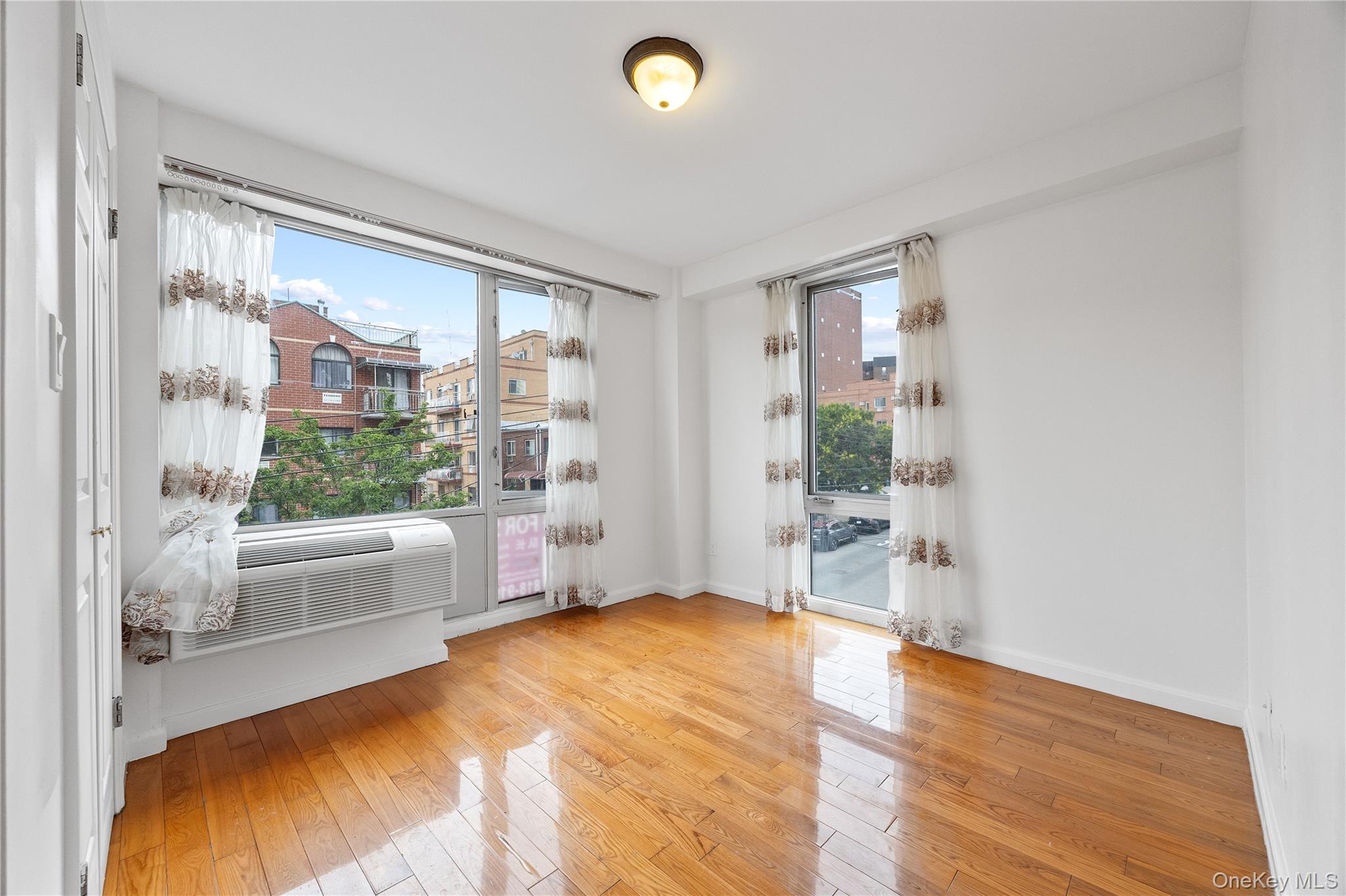 139-30 34th Avenue, Unit 3B Queens, NY 11354 - Photo 15 of 20 a view of an empty room with a window